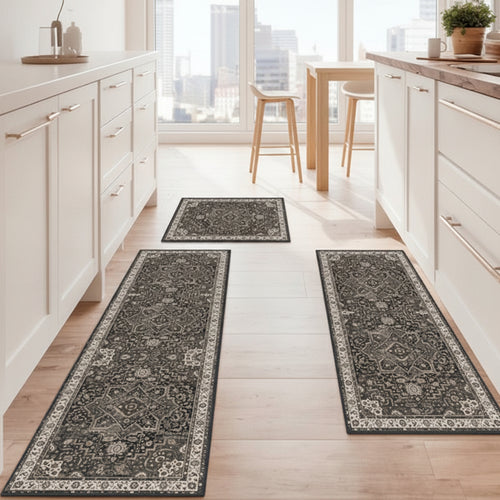 Three decorative rugs on a wooden floor in a kitchen setting.