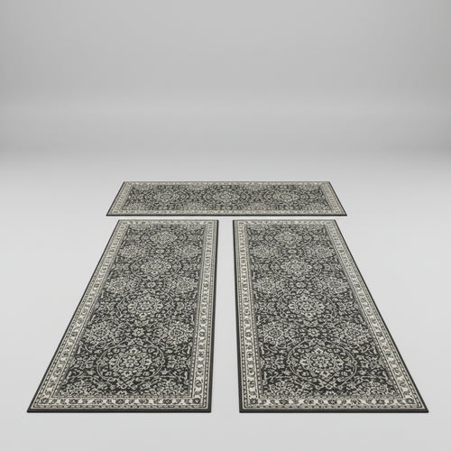 Three decorative rugs on a wooden floor in a kitchen setting.